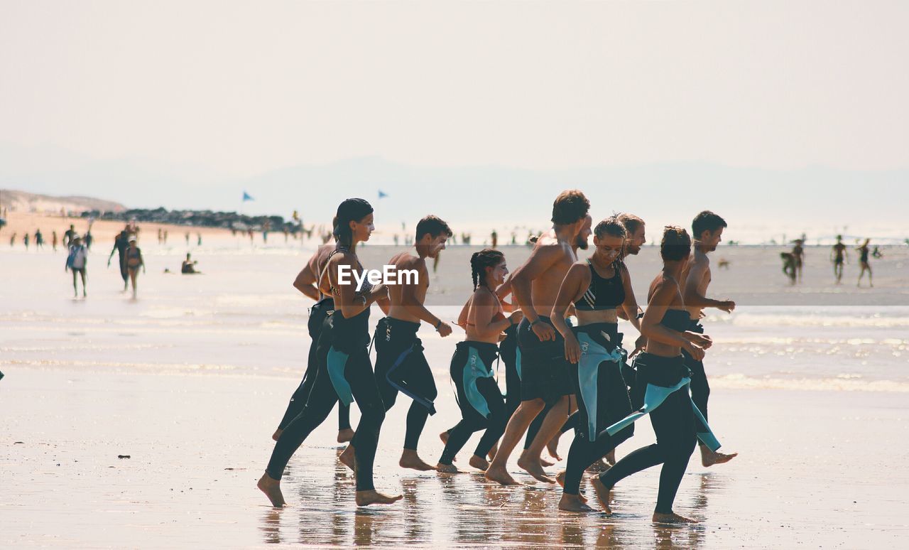 PEOPLE PLAYING ON BEACH