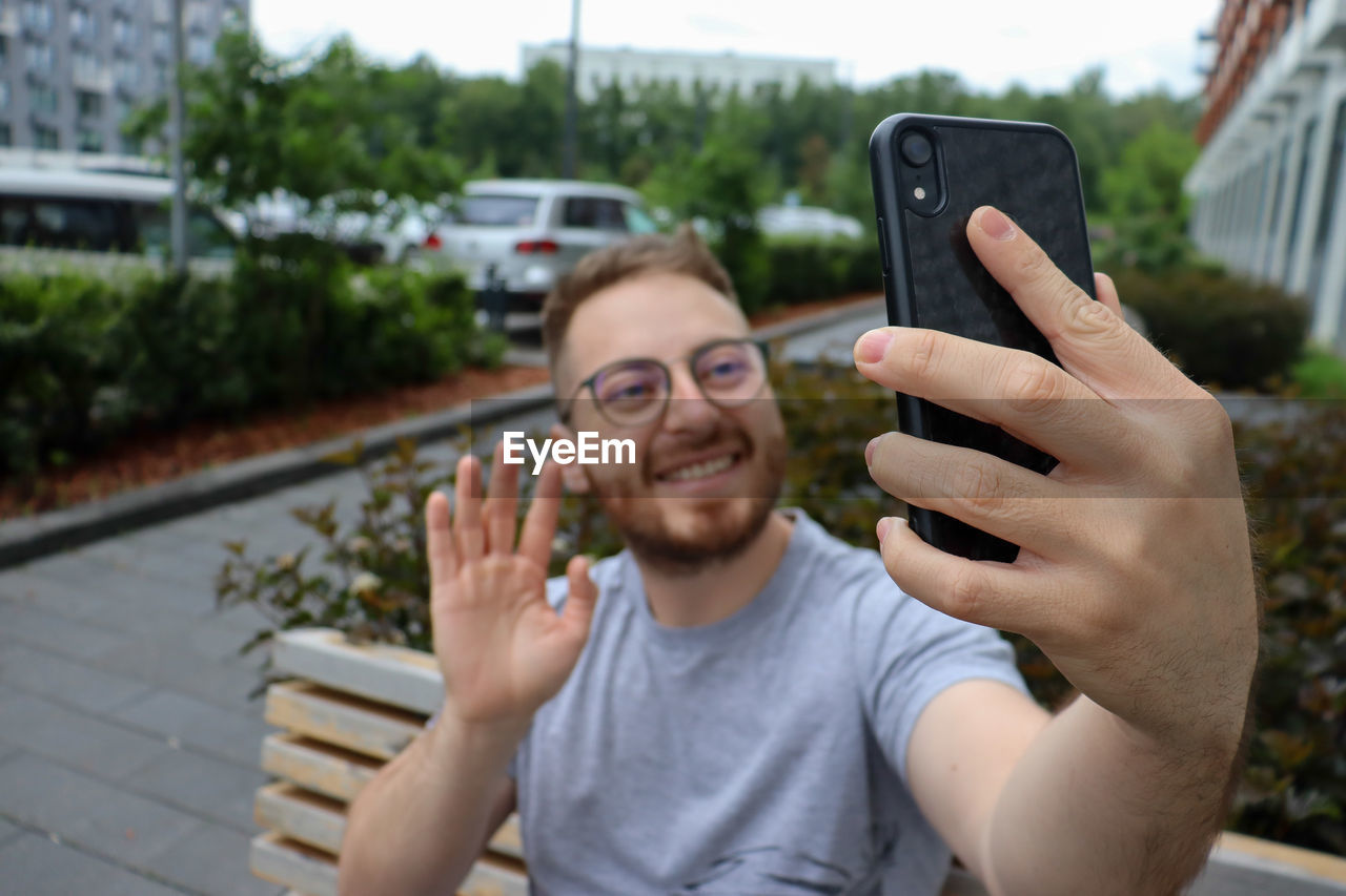 Portrait of young man using mobile phone