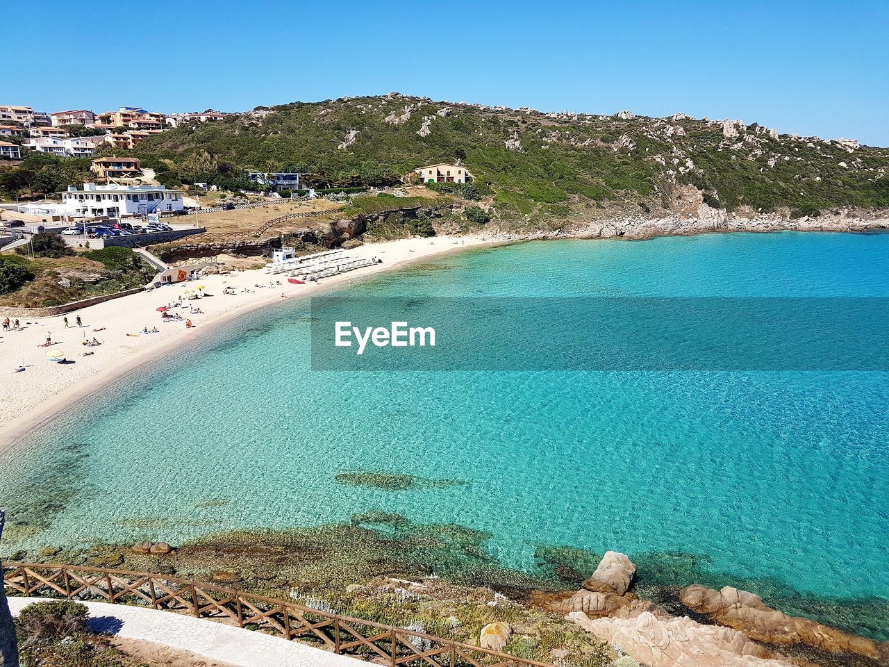 HIGH ANGLE VIEW OF BEACH AGAINST BLUE SKY