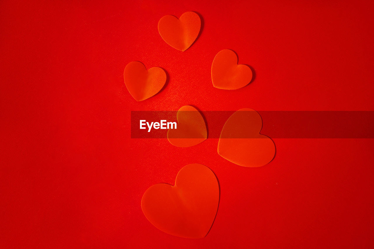 heart, petal, red, circle, no people, colored background, heart shape, pink, orange, love, valentine's day, studio shot, font, positive emotion, creativity, close-up, text, indoors, emotion, shape, backgrounds, macro photography, red background, orange color, nature, vibrant color, simplicity, abstract
