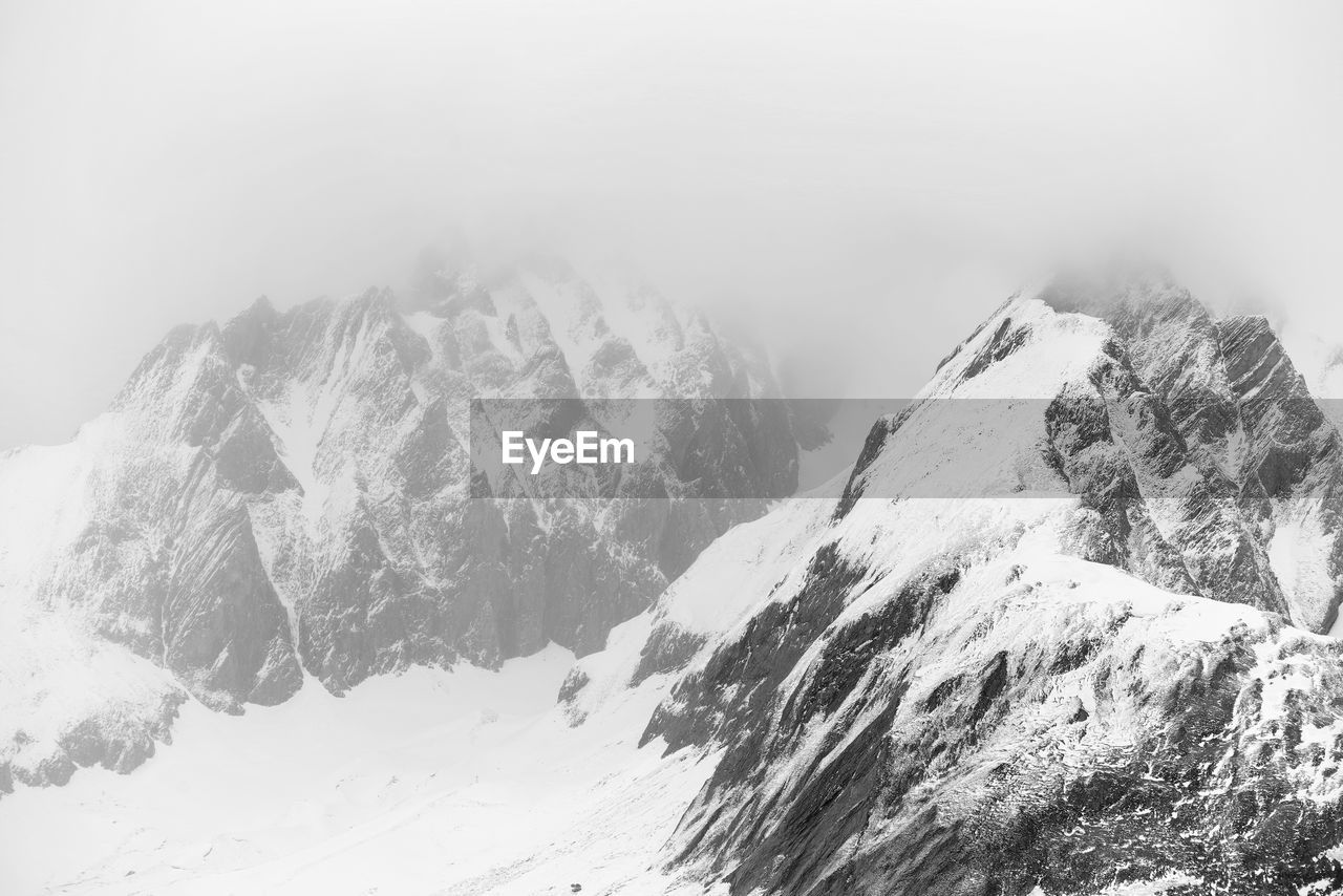 Scenic view of snow covered mountains against sky