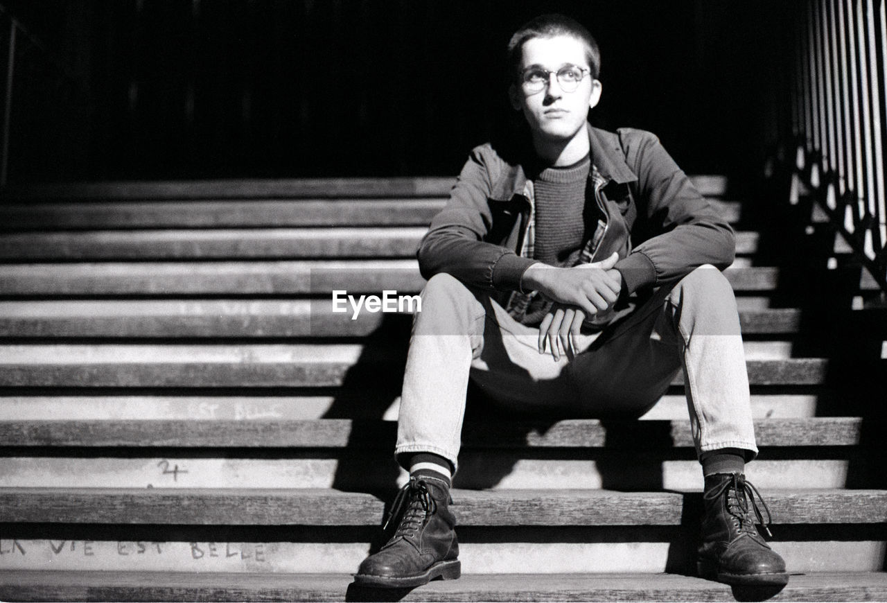 Portrait of young man sitting on bench