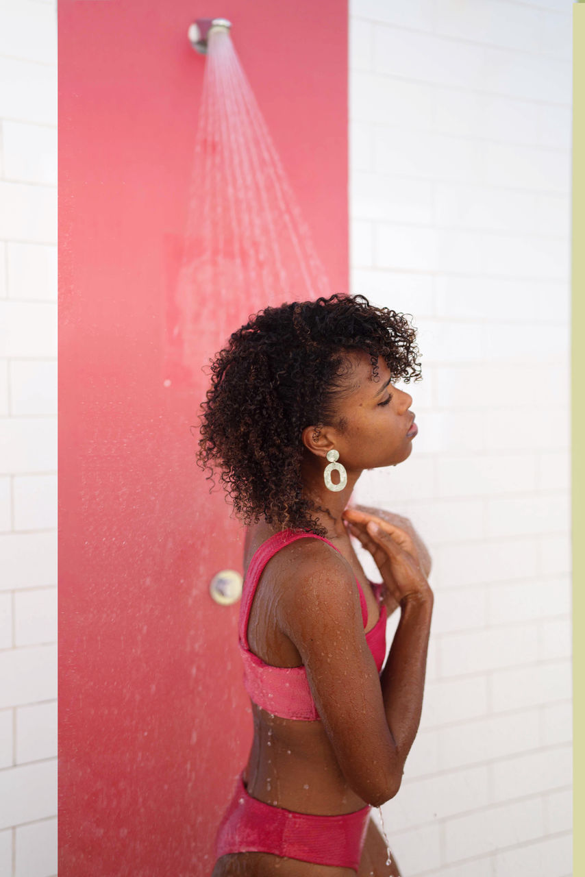 Woman in the colorful outdoor shower