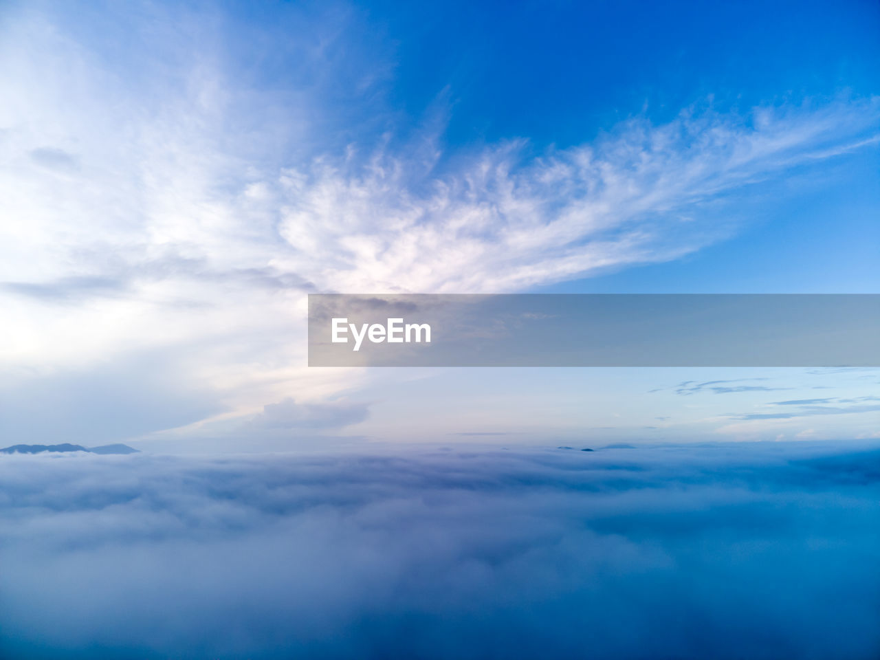 sky, cloud, blue, horizon, cloudscape, environment, beauty in nature, scenics - nature, nature, atmosphere, tranquility, backgrounds, dramatic sky, idyllic, sunlight, tranquil scene, fluffy, no people, wind, copy space, aerial view, high up, daytime, outdoors, white, overcast, meteorology, space, landscape, urban skyline, fog, light - natural phenomenon, moody sky, awe, travel, day, above, flying, summer, mid-air, vibrant color, dawn, atmospheric mood, airplane, sun, spirituality, softness, ethereal