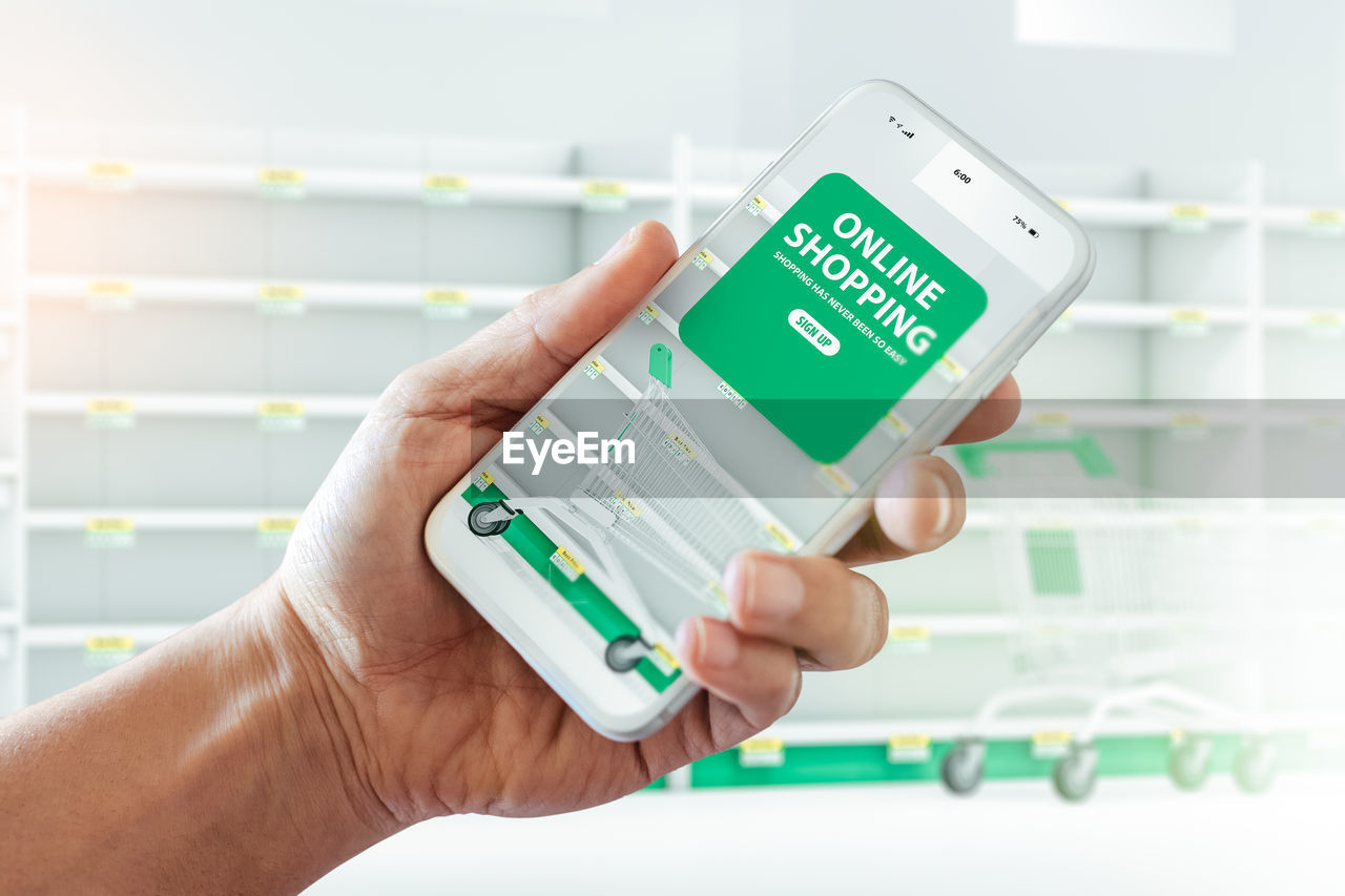 Man using a phone to shop at the internet supermarket in the coronavirus crisis