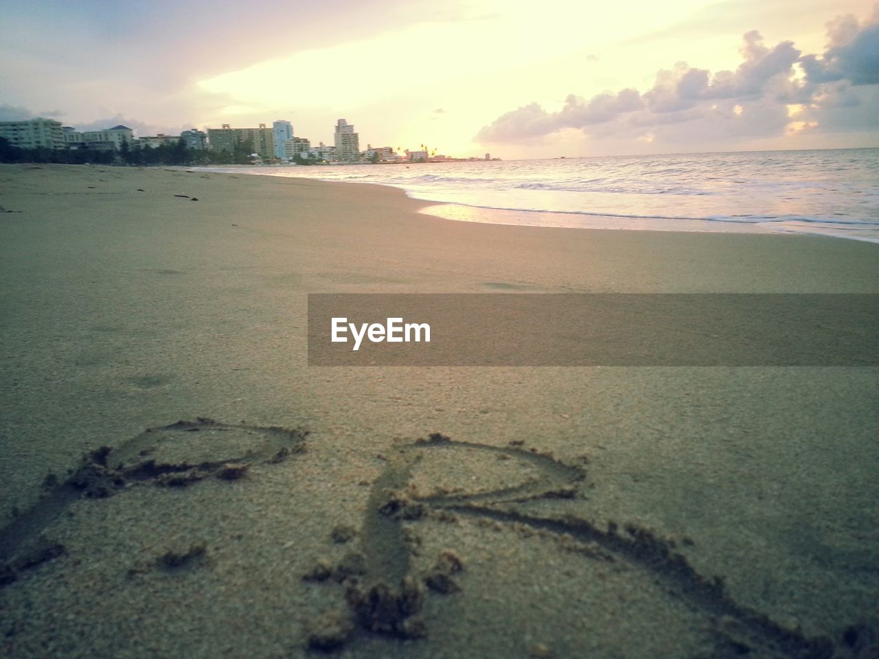 Text on beach during sunset