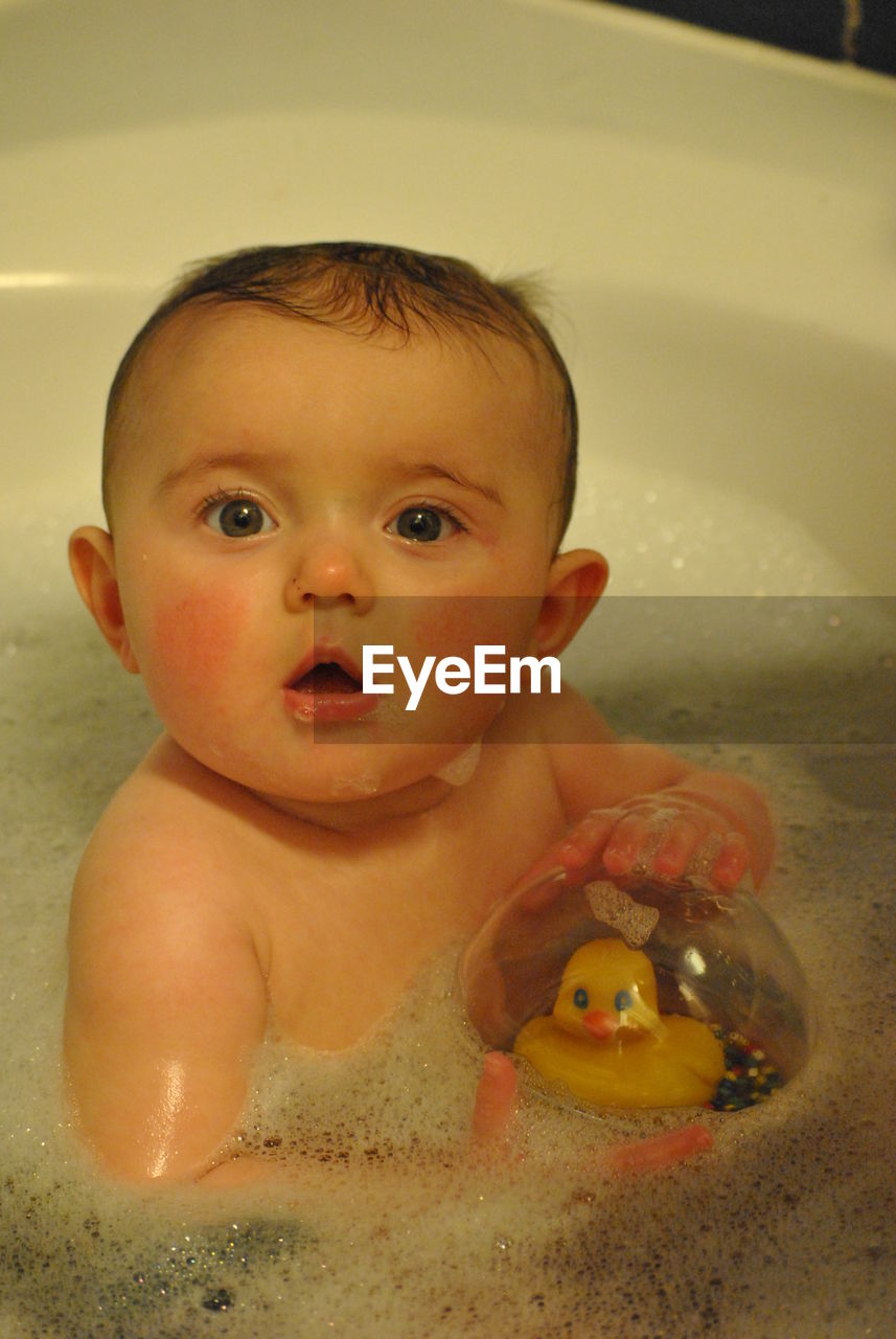 Portrait of baby boy in bathtub