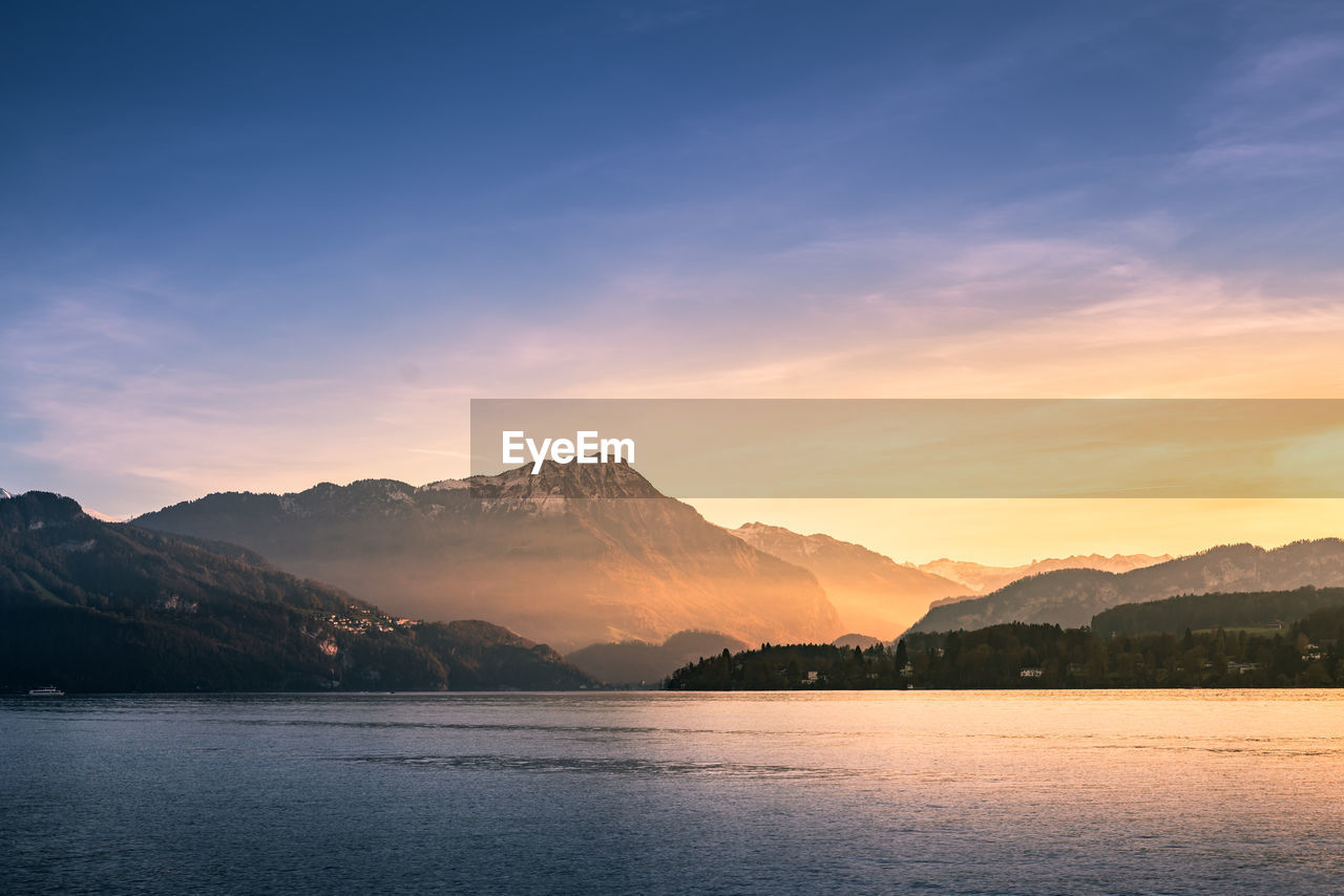 Scenic view of lake against sky during sunset