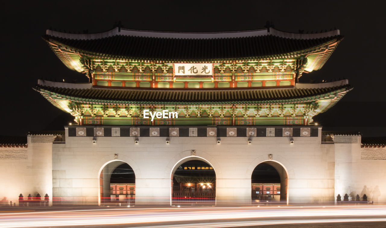 LOW ANGLE VIEW OF ILLUMINATED BUILDING