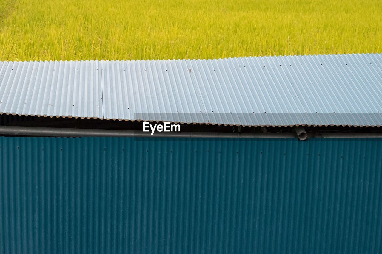 High angle view of corrugated iron by grassy field