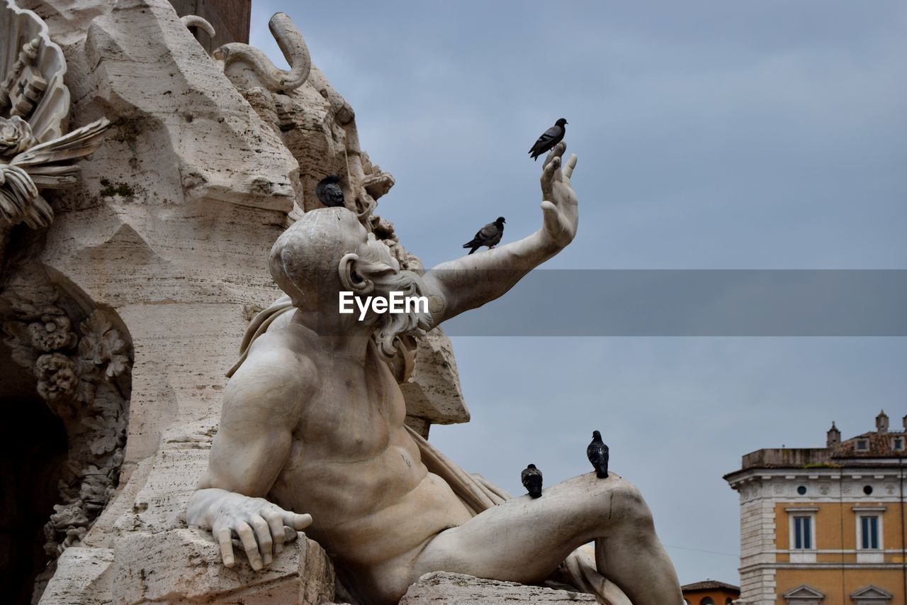 Low angle view of statue against sky