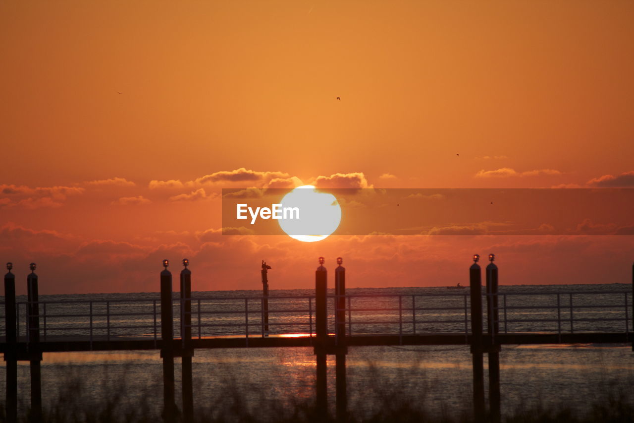 Sunset with dock near fort desota, florida