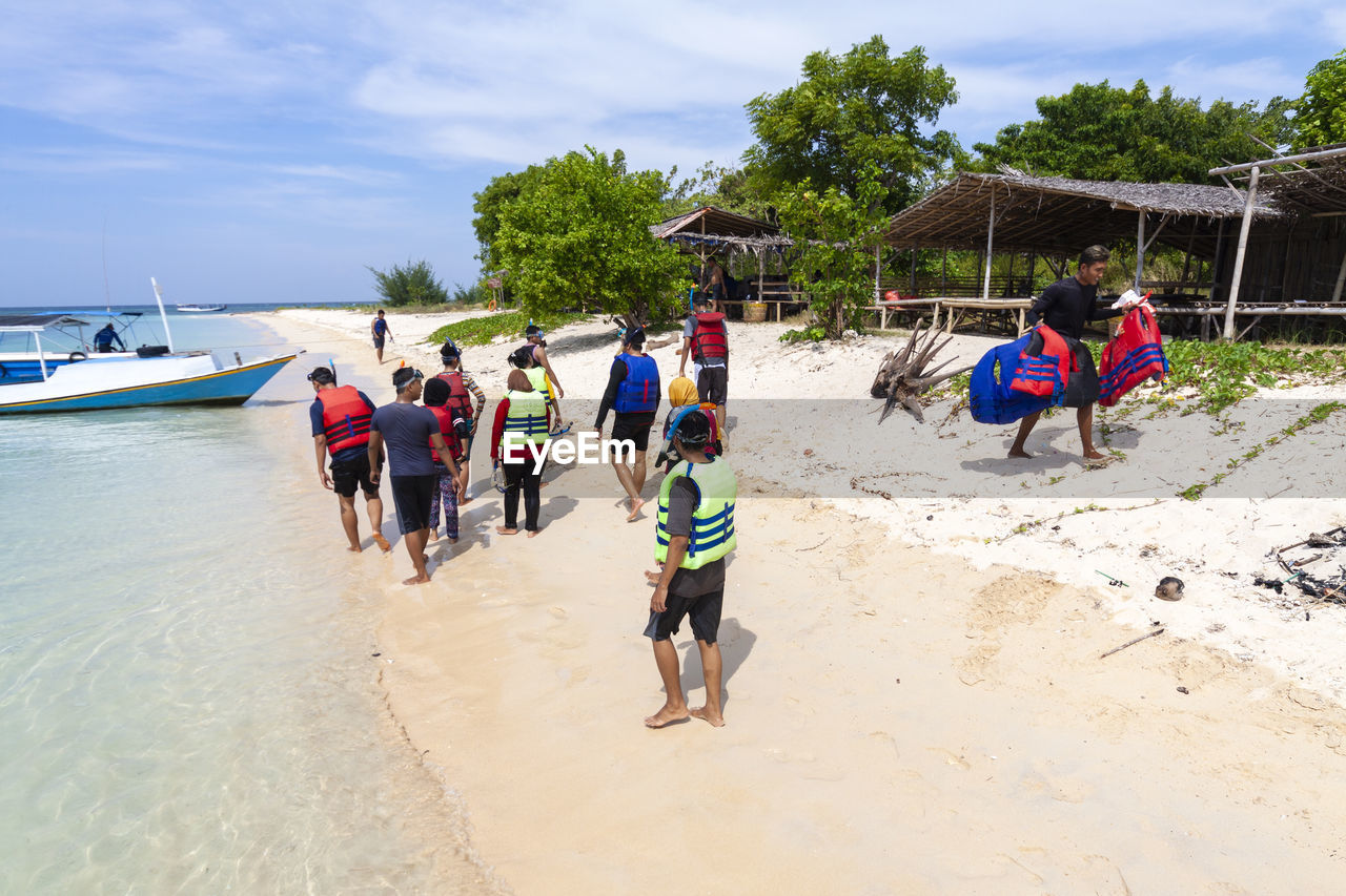 PEOPLE ENJOYING ON BEACH