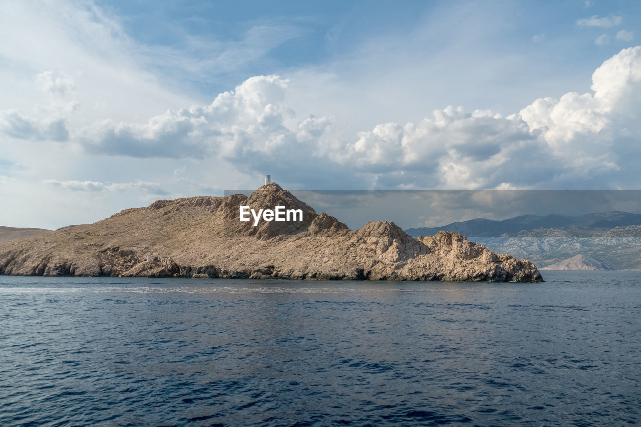 Scenic view of sea and mountains against sky