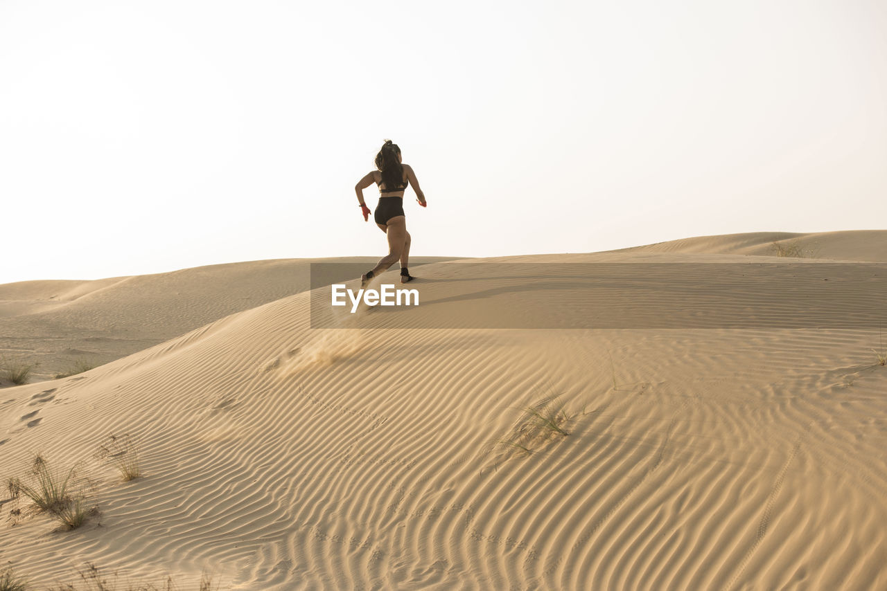 Woman walking in desert