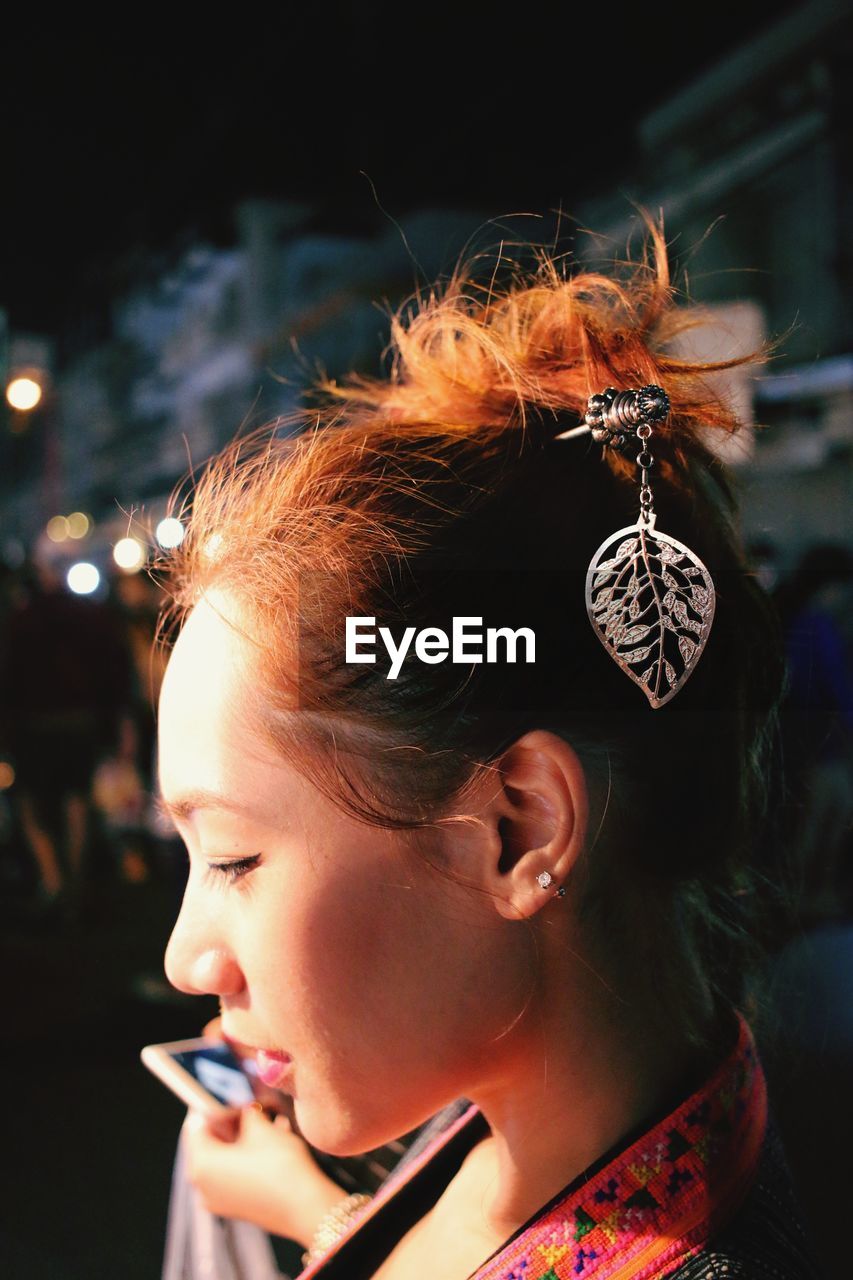 Side view of young woman with barrette