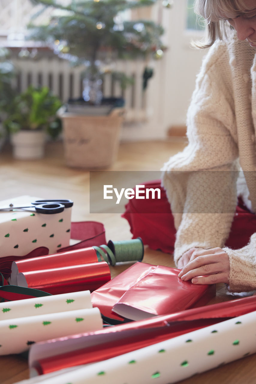 Woman's hands packing christmas presents