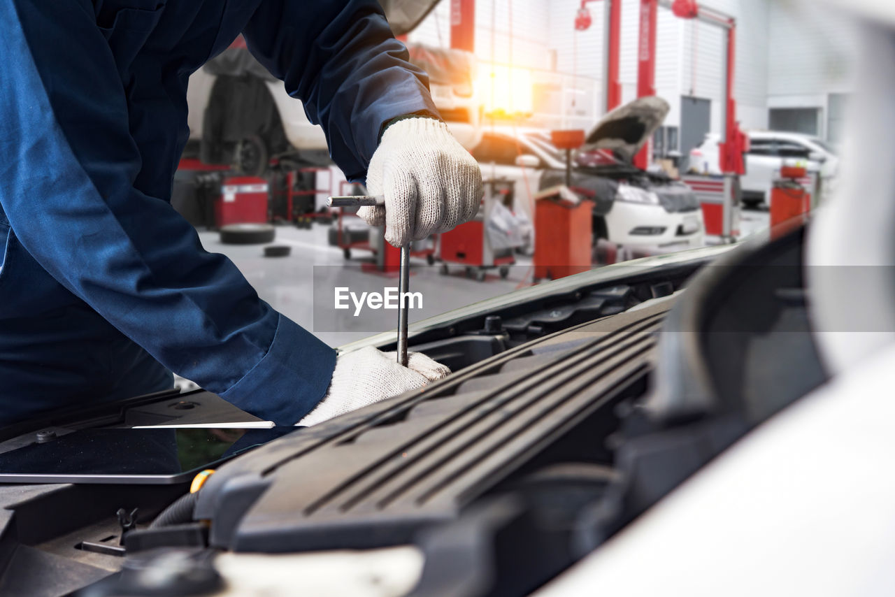 midsection of man working in workshop