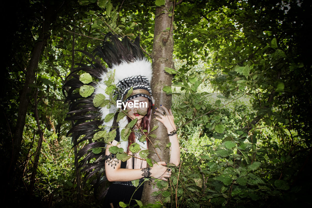 Portrait of woman wearing headdress in forest