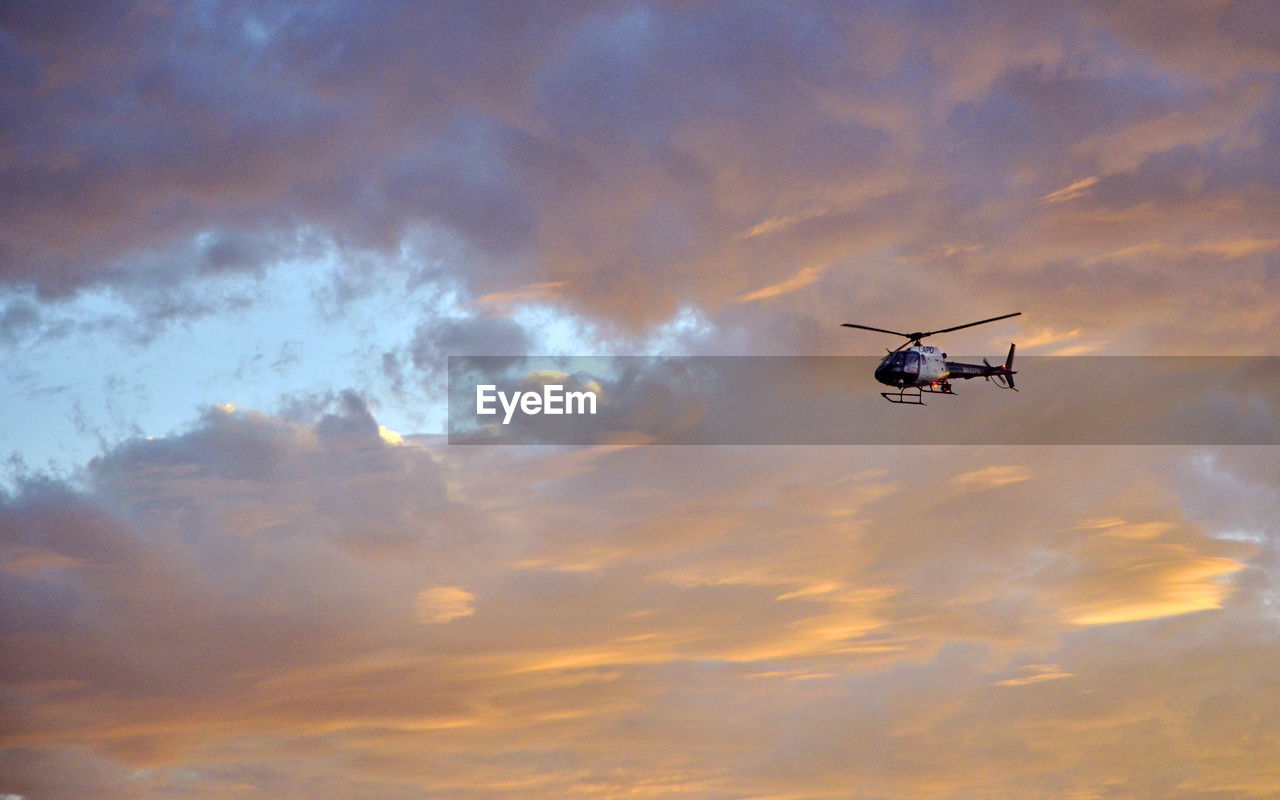 Low angle view of helicopter against sky