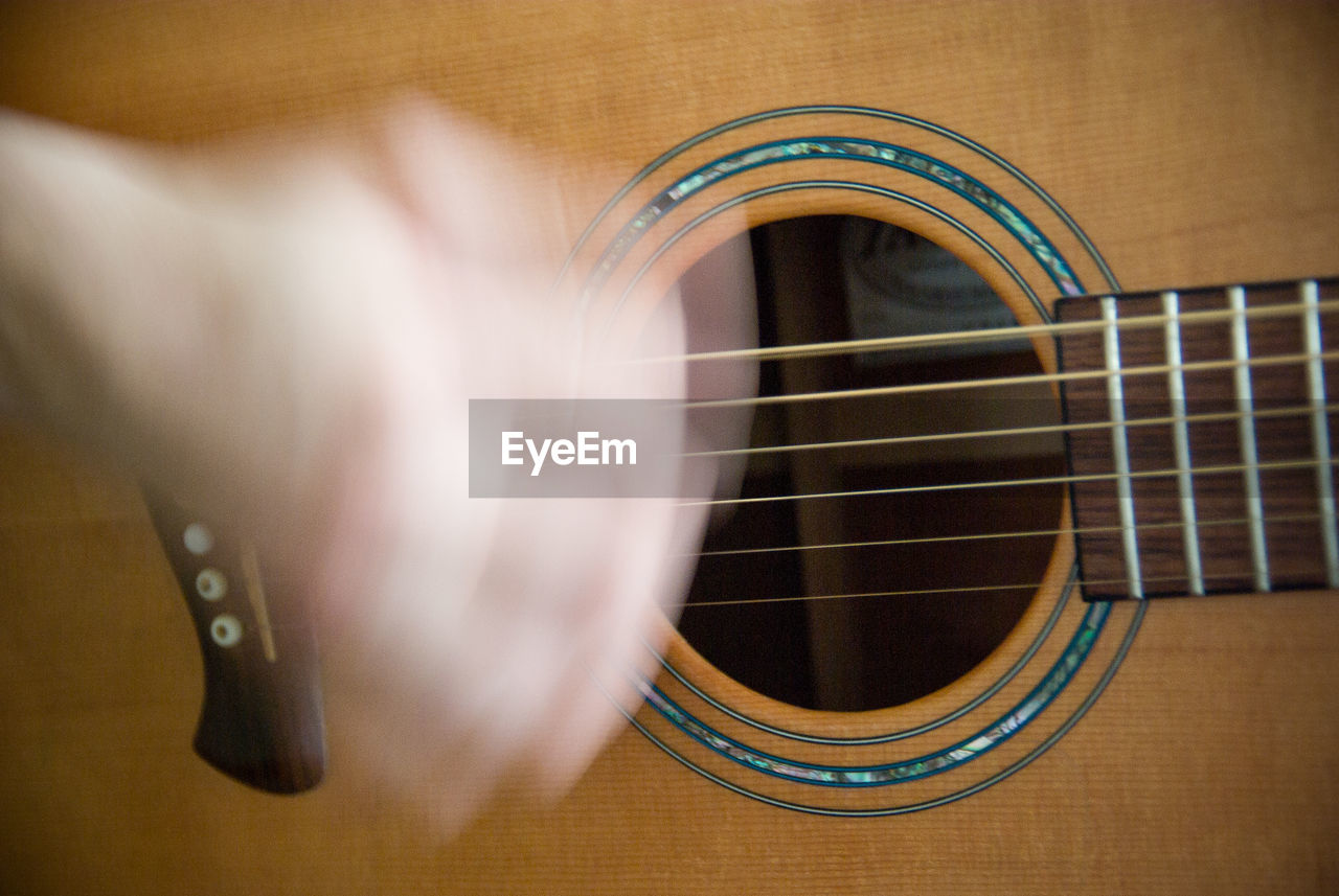 Cropped hand playing guitar