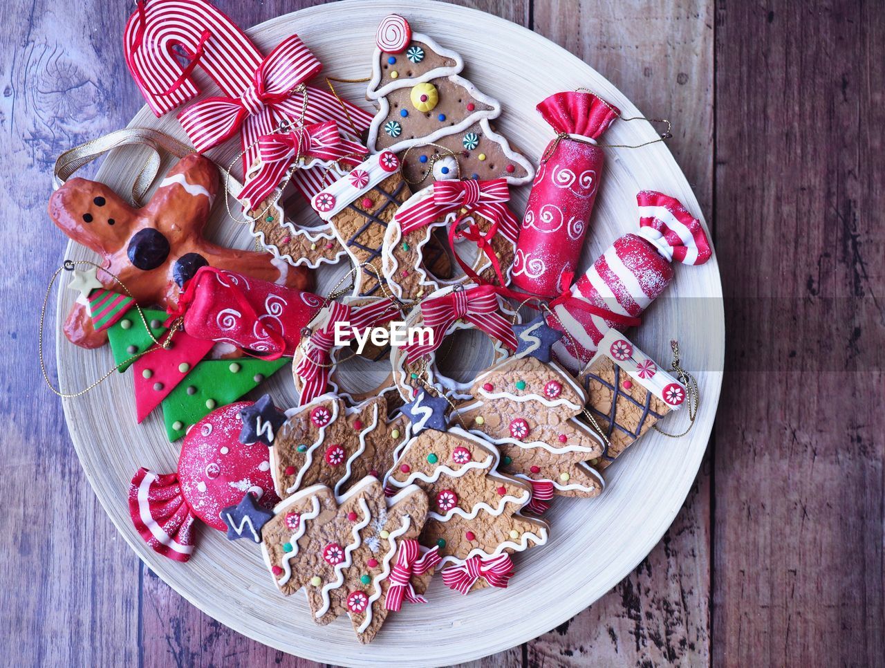 Directly above shot of gingerbread cookies and candies on table during christmas