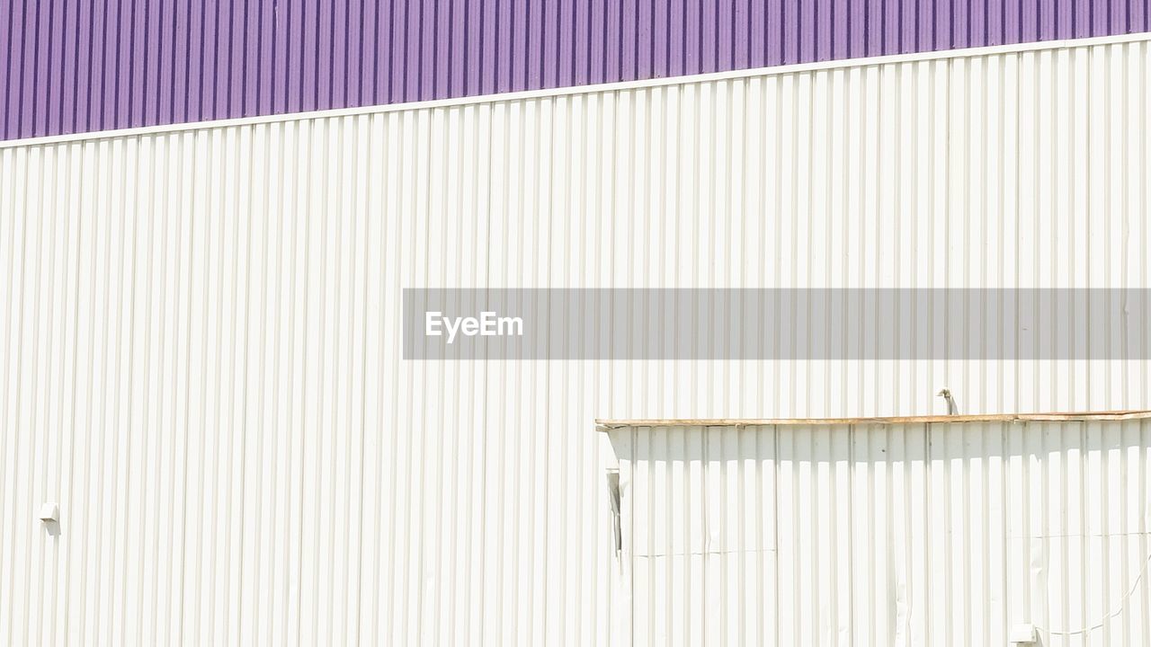 Full frame shot of corrugated factory wall during sunny day