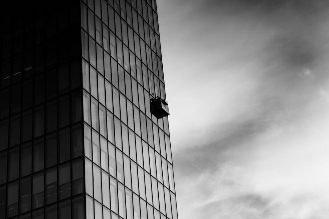 Modern building in city against cloudy sky