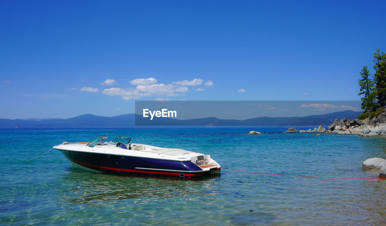 BOAT ON SEA AGAINST BLUE SKY