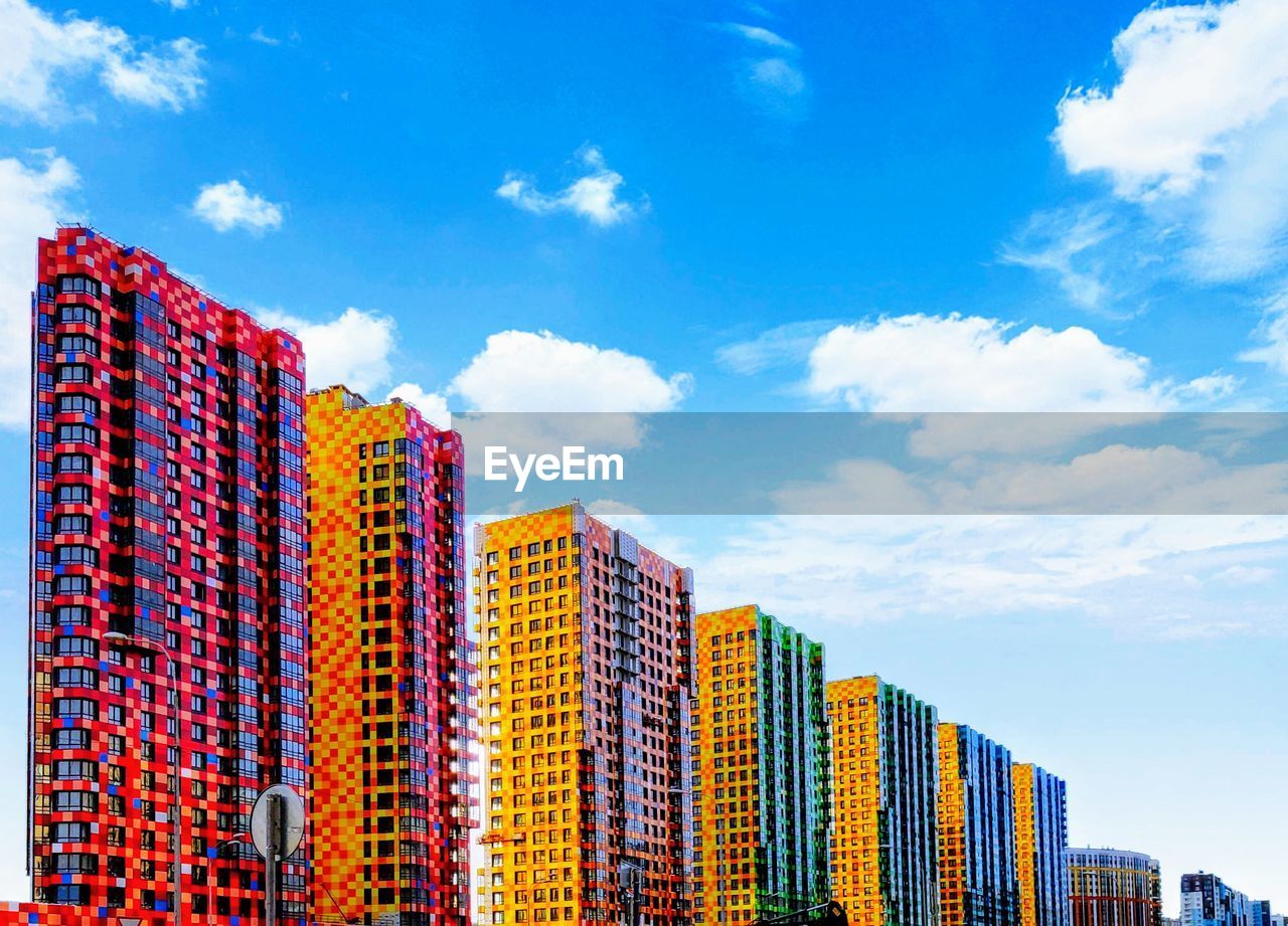 Low angle view of multi colored modern buildings against sky