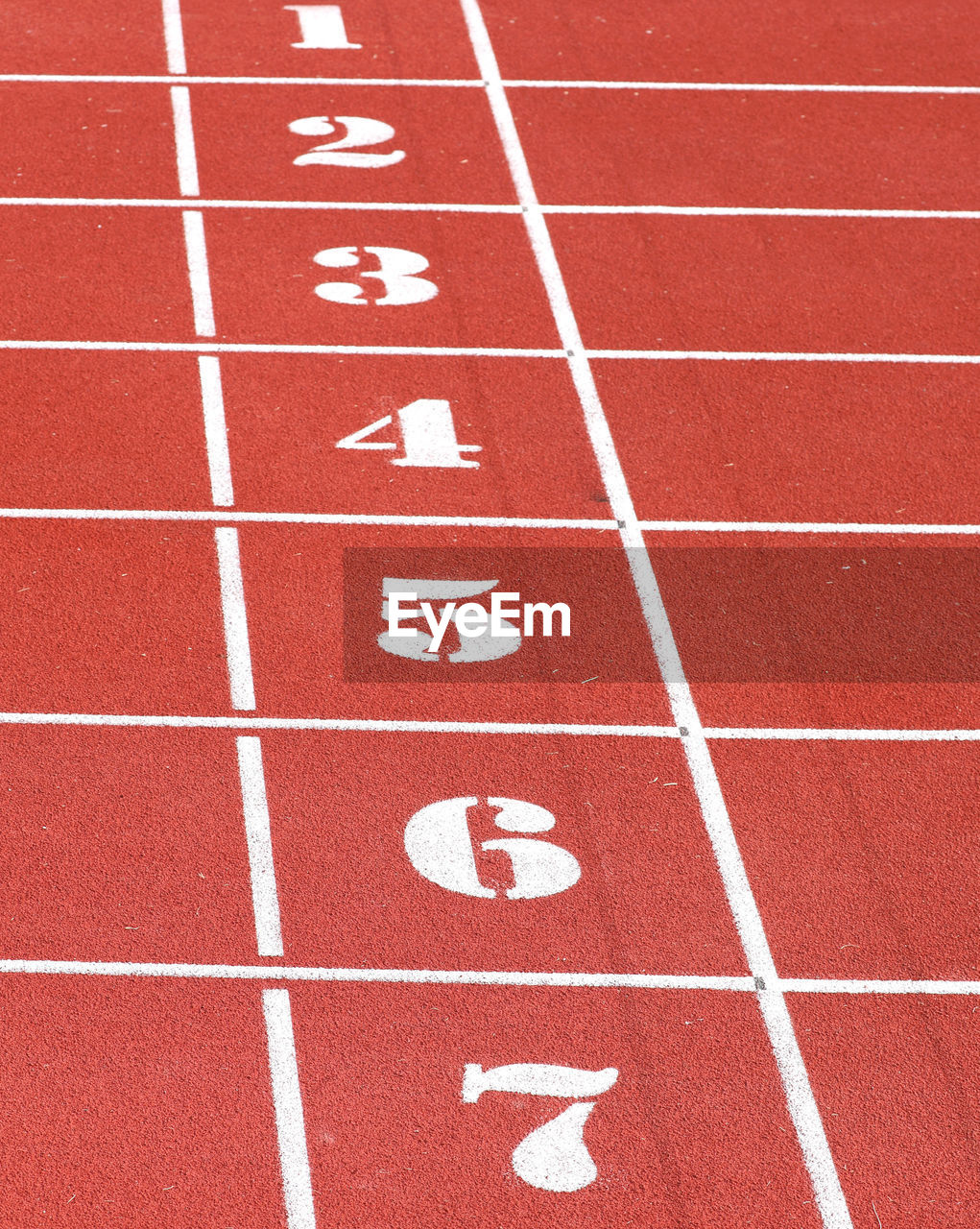 Numbers from one to seven of the athletics track lane before the speed race arrives