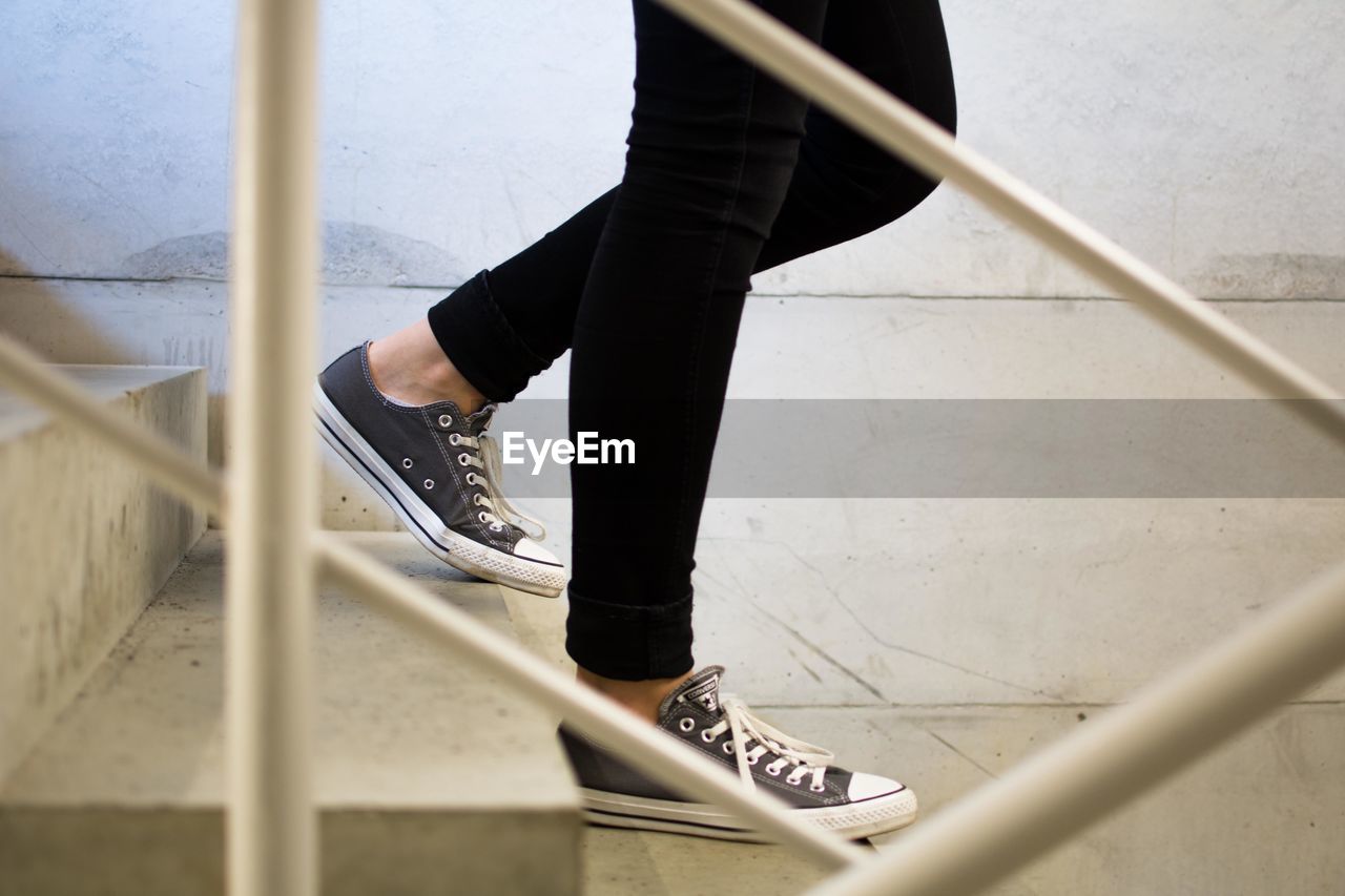 Side view low section of woman walking down stairs