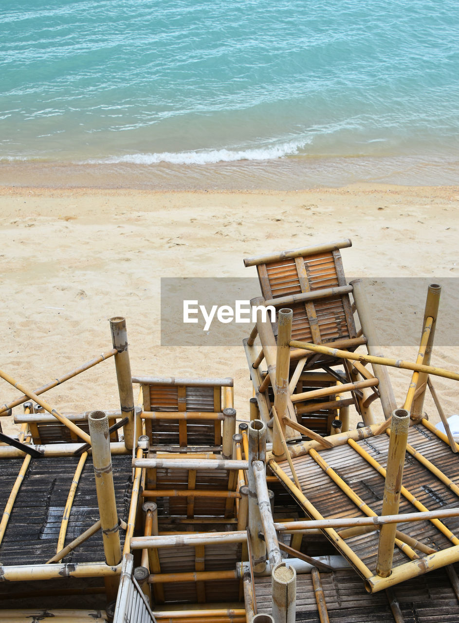 High angle view of wooden tables at beach