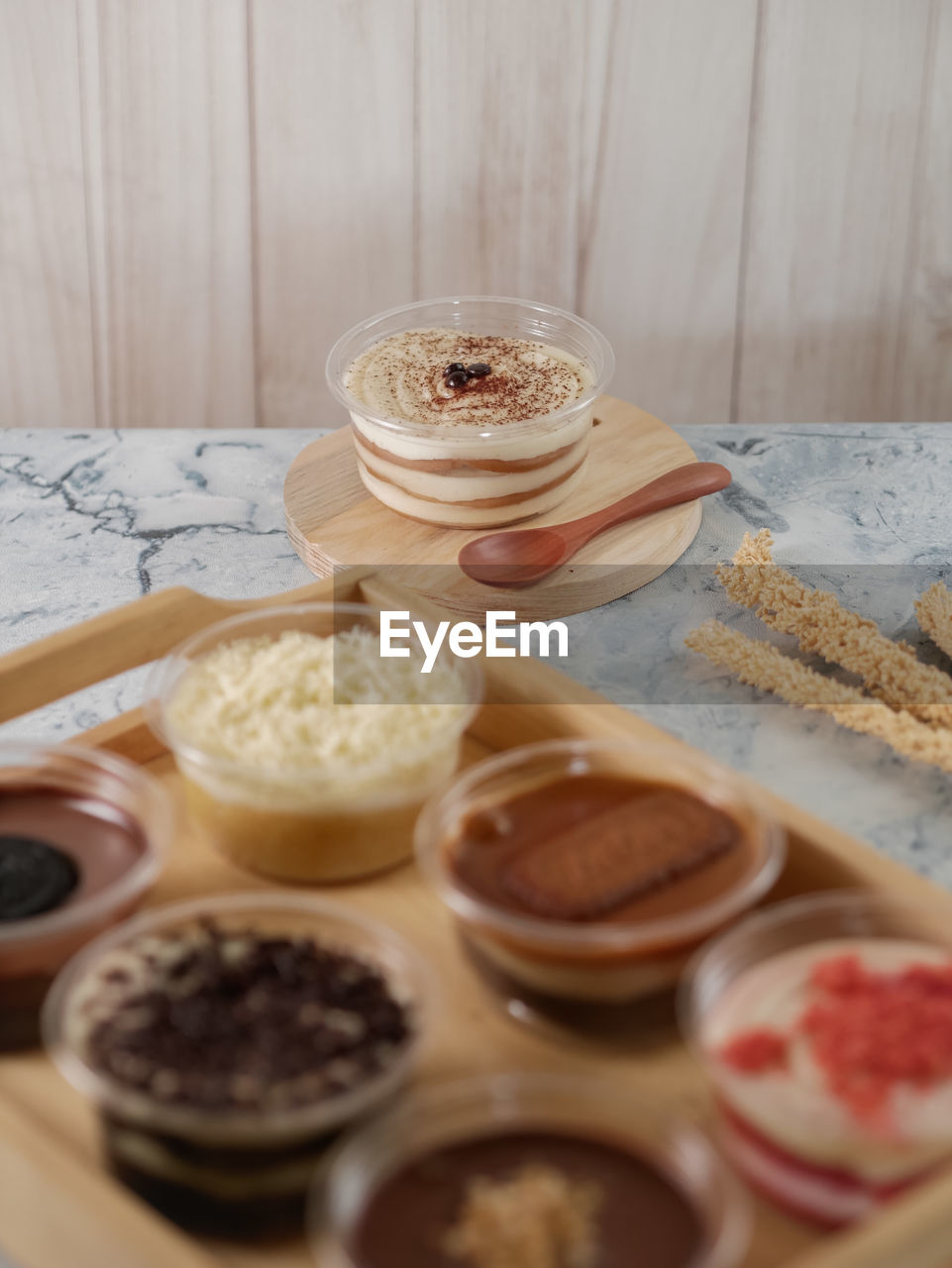 Desserts on a cup served on the table with wooden ware