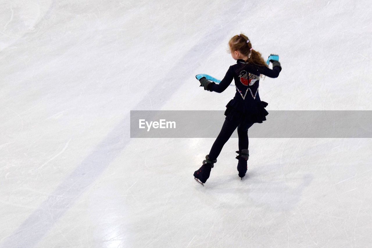 Rear view full length of girl ice-skating