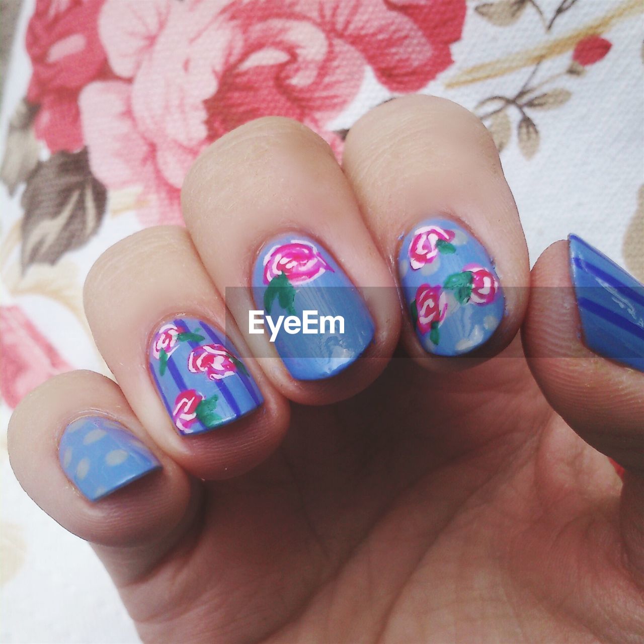 Cropped image of woman showing nail art