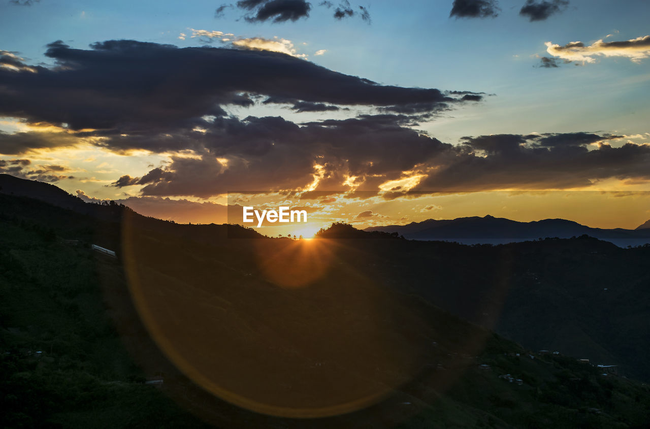 SCENIC VIEW OF SUNSET OVER MOUNTAIN