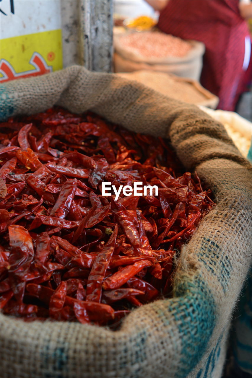 CLOSE-UP OF RED CHILI PEPPERS ON TABLE