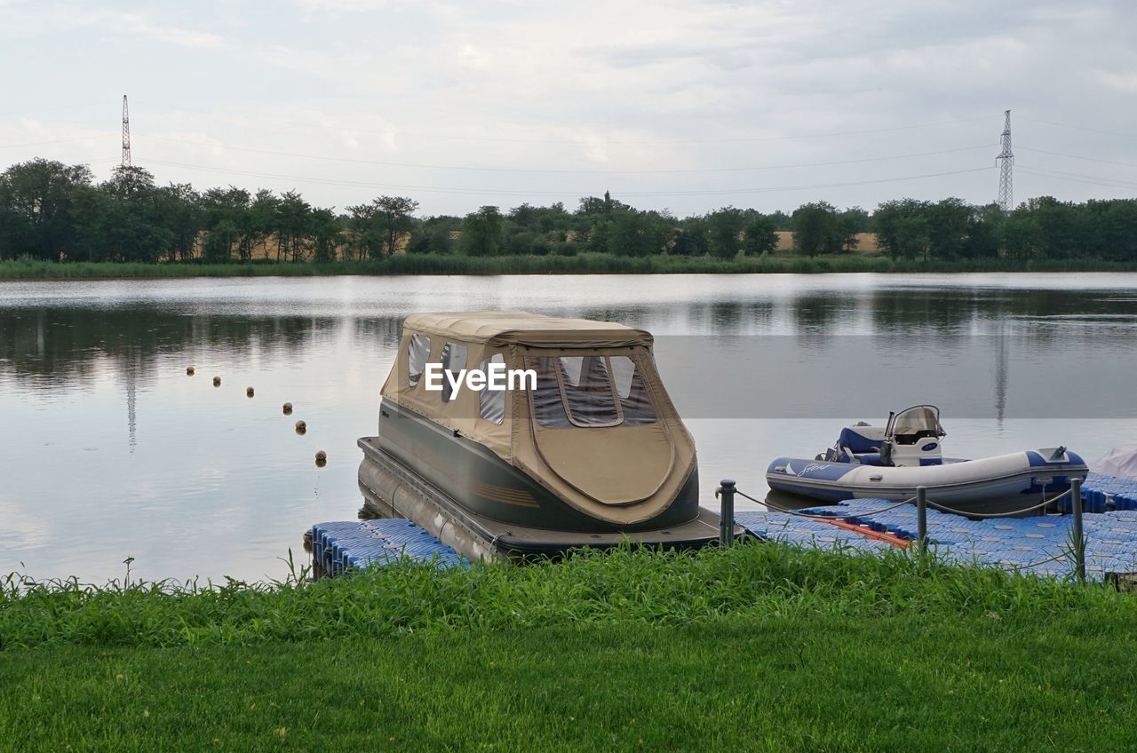 BOATS MOORED AT LAKESHORE