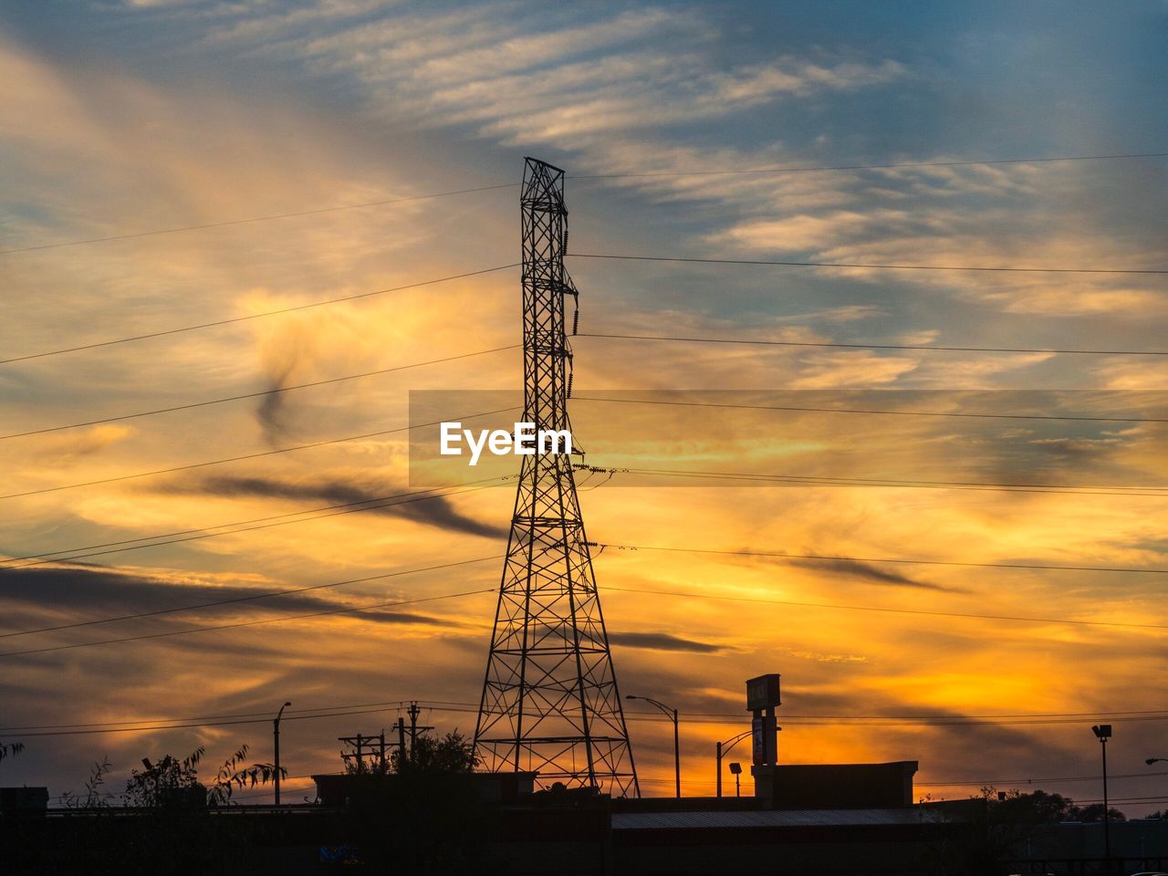 LOW ANGLE VIEW OF ELECTRICITY PYLON AGAINST CLOUDY SKY