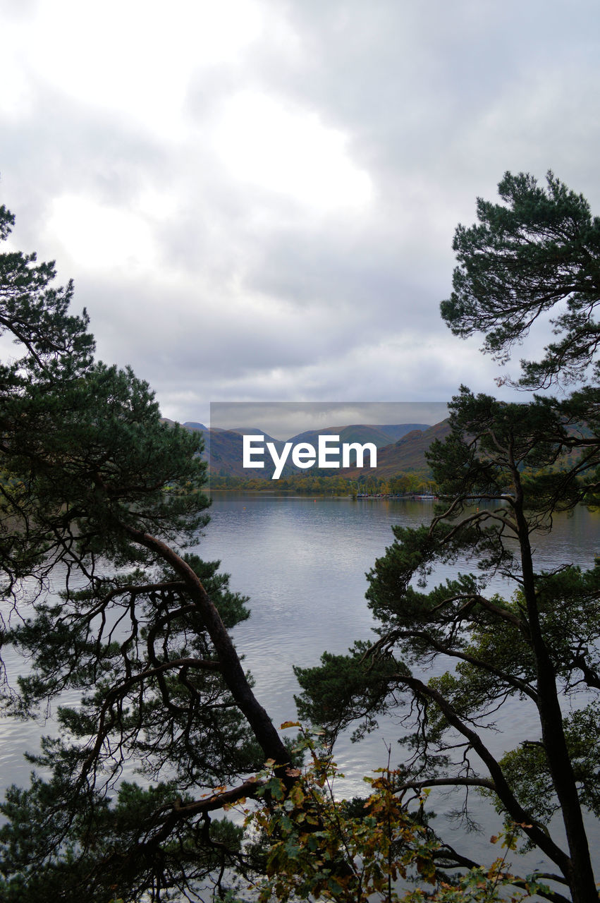 Scenic view of lake against cloudy sky