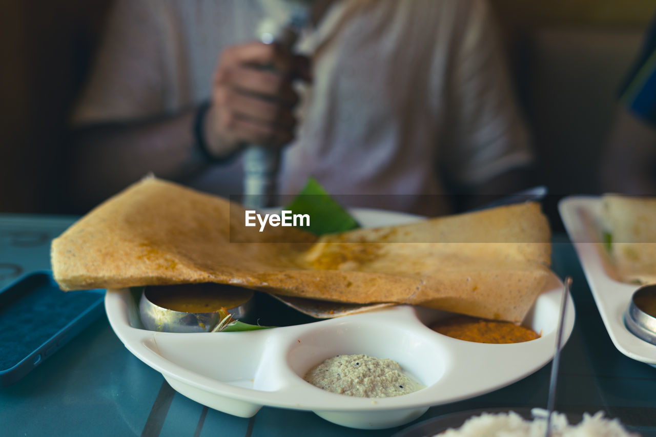 midsection of man holding food