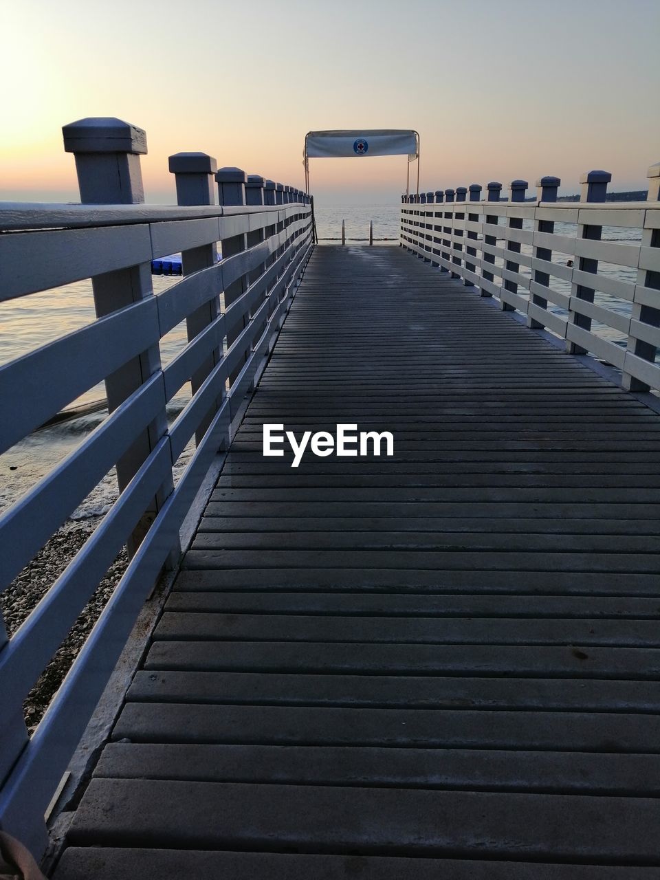 View of pier on sea against sky during sunset