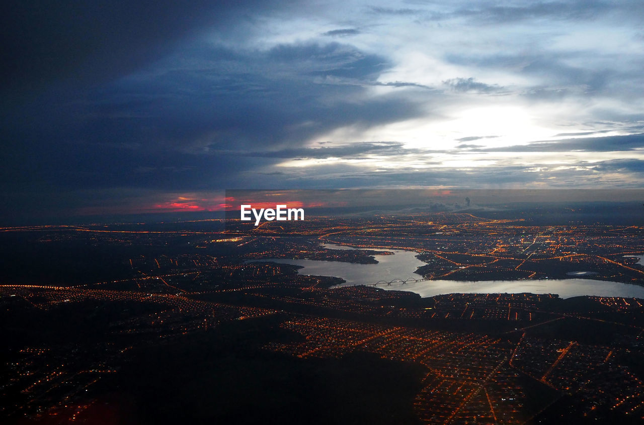 Aerial view of city against cloudy sky