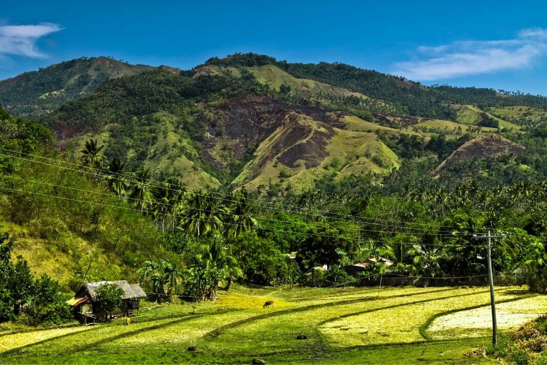 Countryside landscape against blue sky