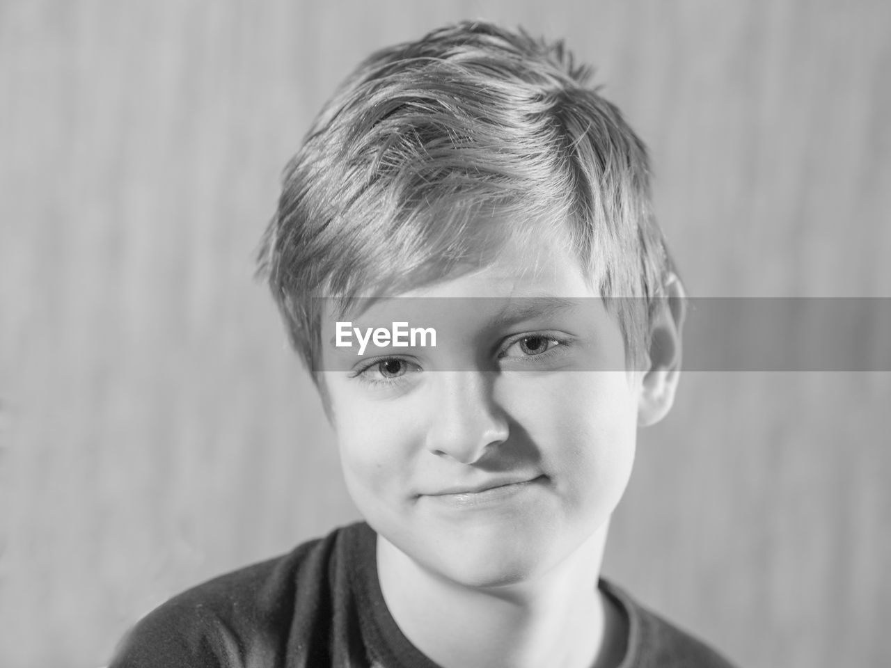 Black and white portrait of caucasian boy on grey background