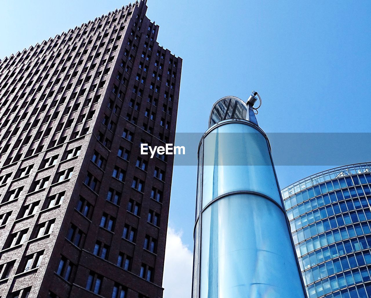 Low angle view of modern building against blue sky