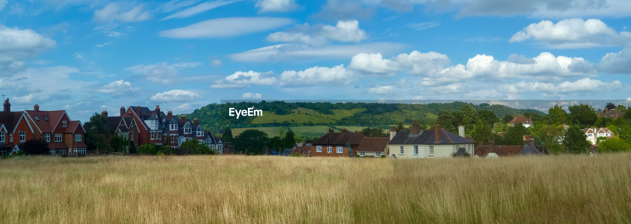 Houses on field against sky