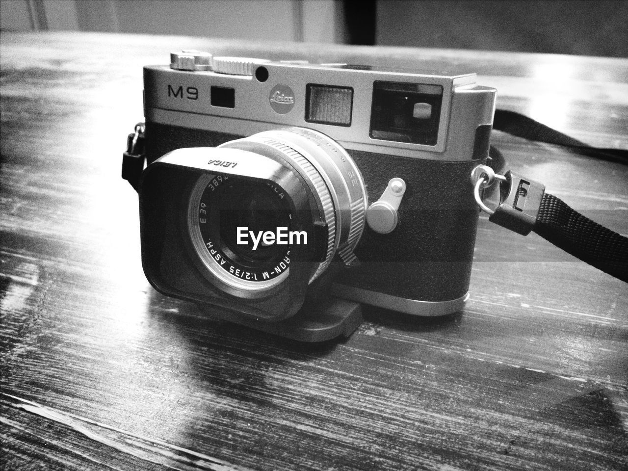 CLOSE-UP OF VINTAGE CAMERA ON TABLE AT HOME