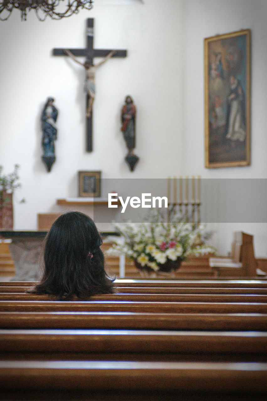 Rear view of woman sitting in church